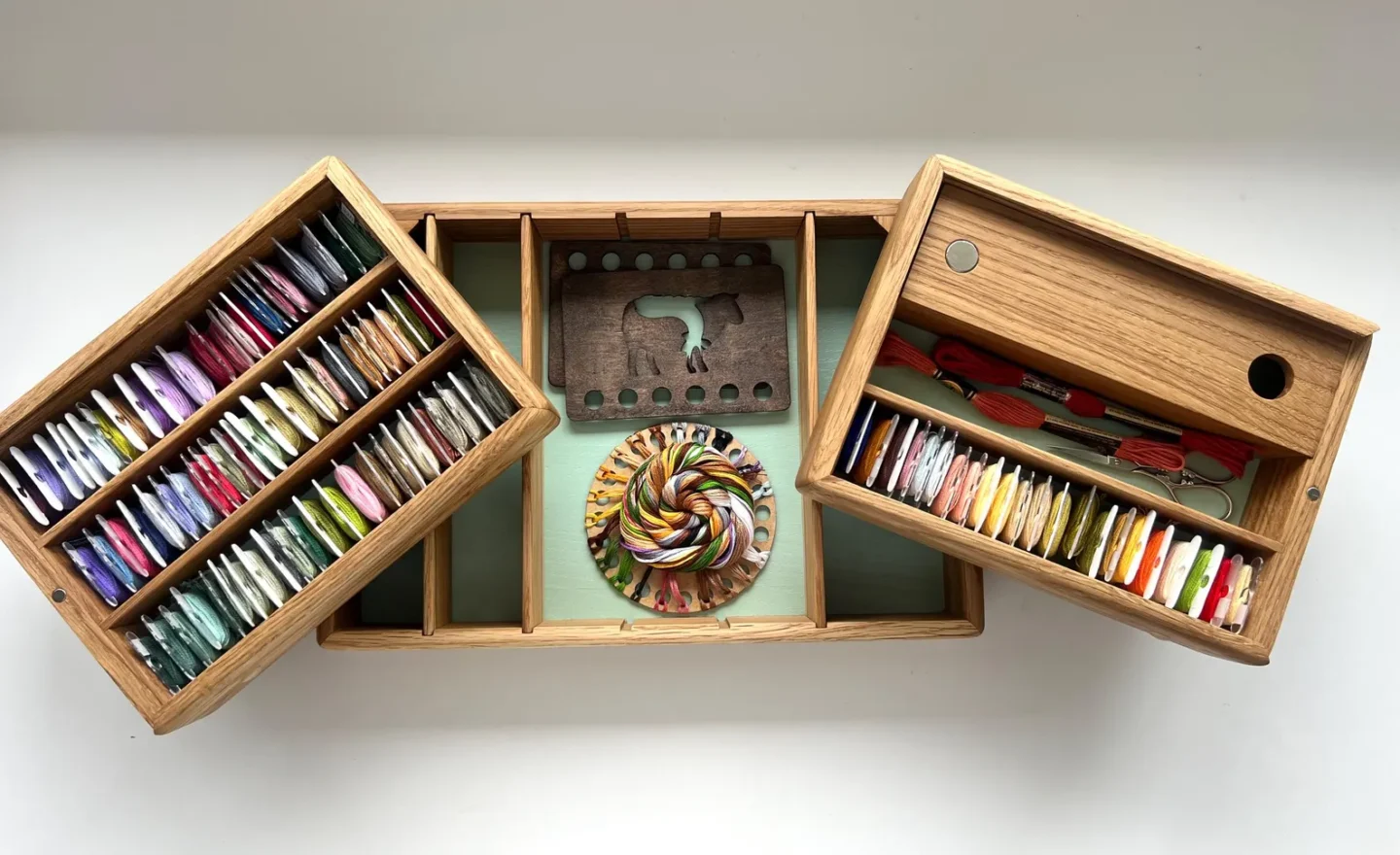 expandable oak wood floss organizer with embroidery floss and embroidery notions inside