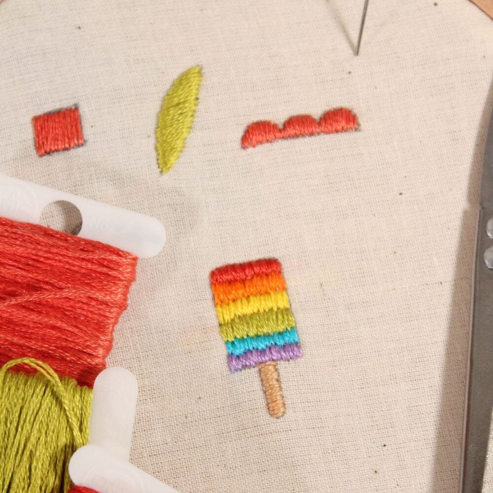 embroidery of a colorful popsicle using the satin stitch