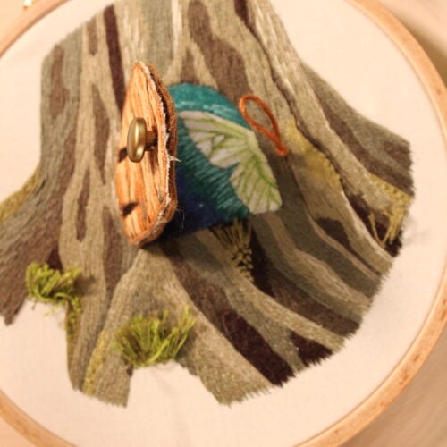 IMG_1980 closeup of a fairy door that is ajar, revealing a green fairy