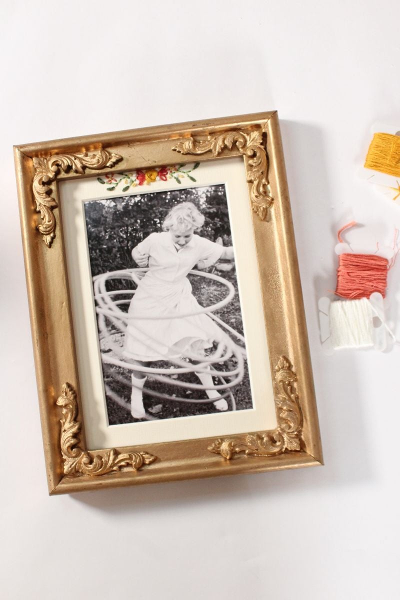 embroidered photo mat in a decorate gold frame