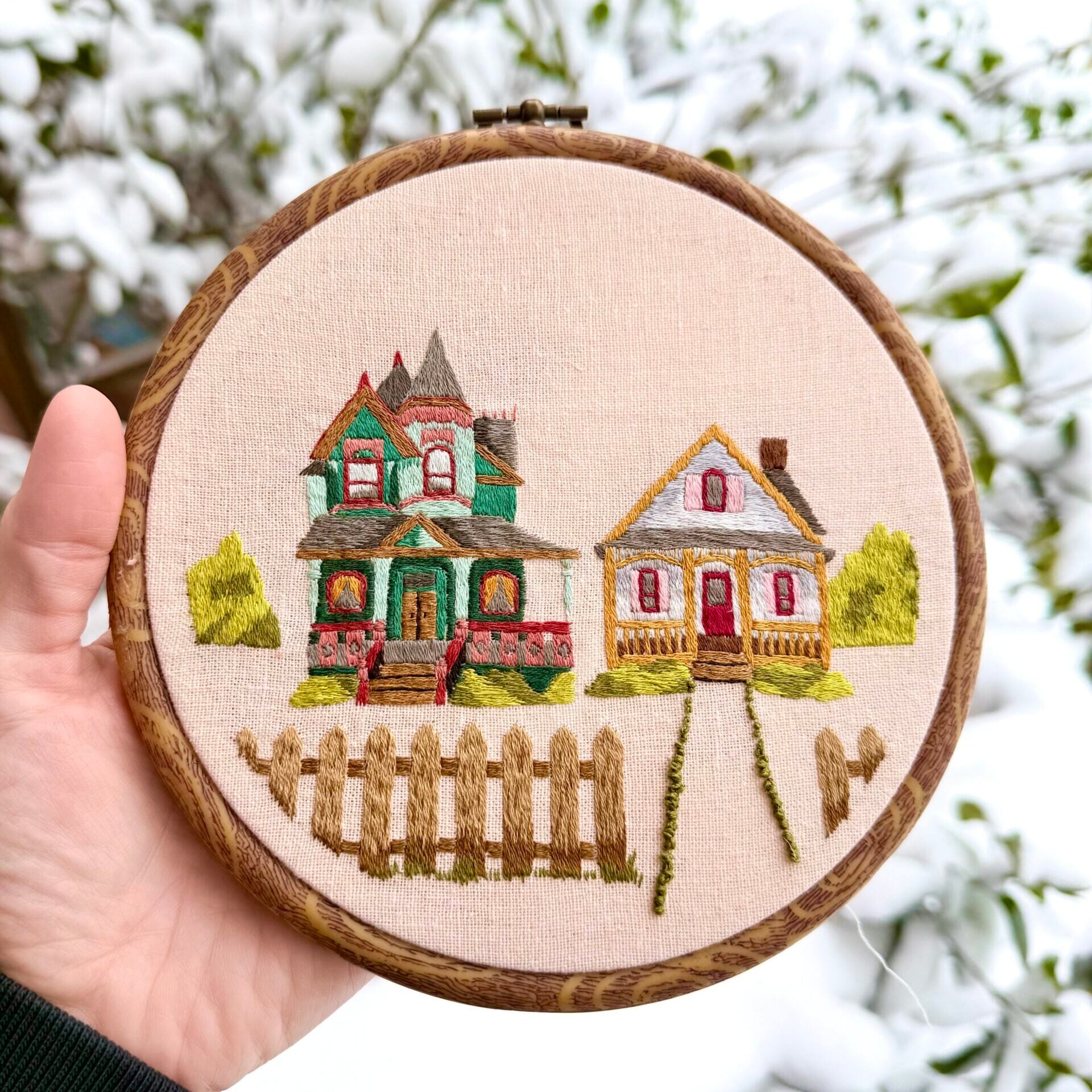 embroidery of colorful victorian houses on a street