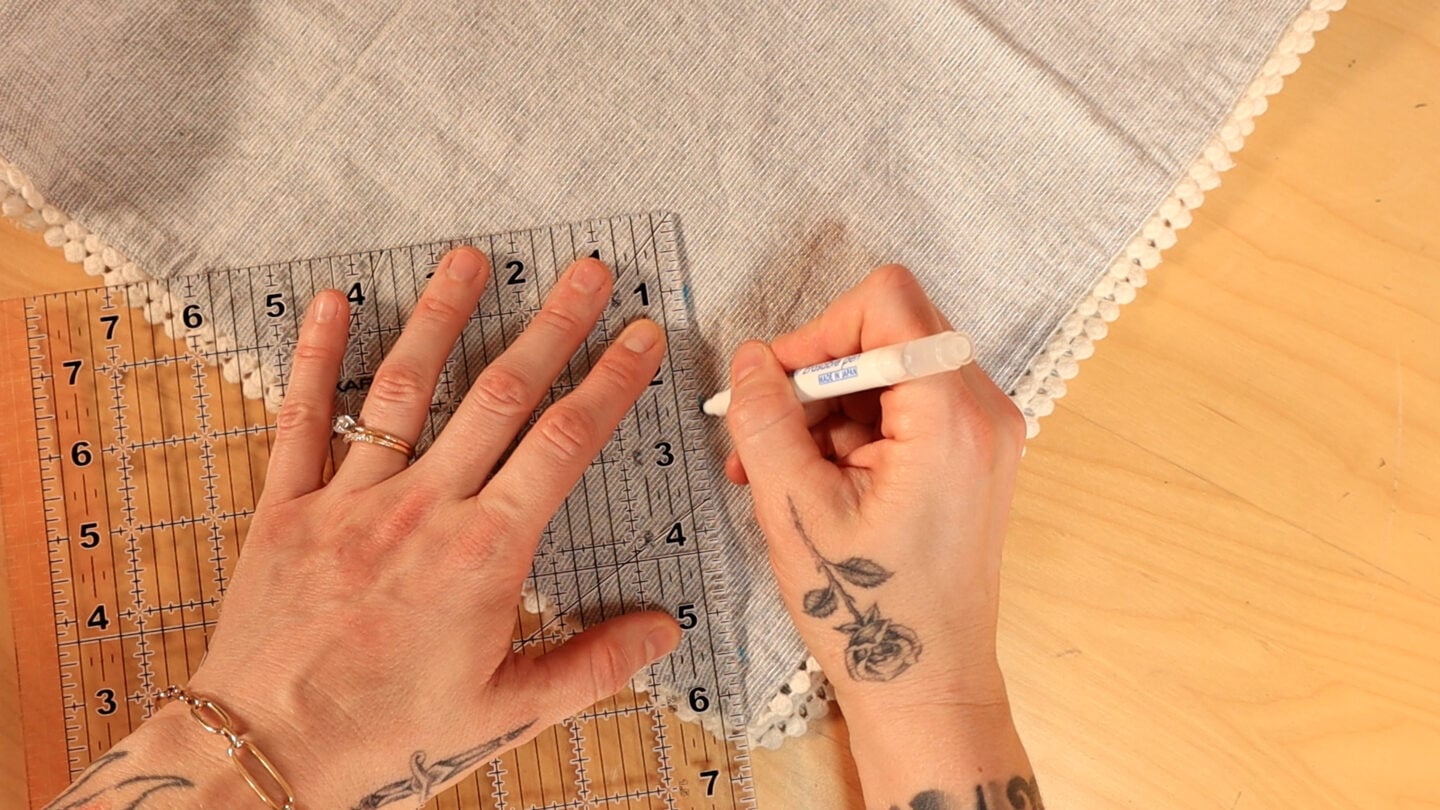 marking out the center along the corner of the cloth napkin
